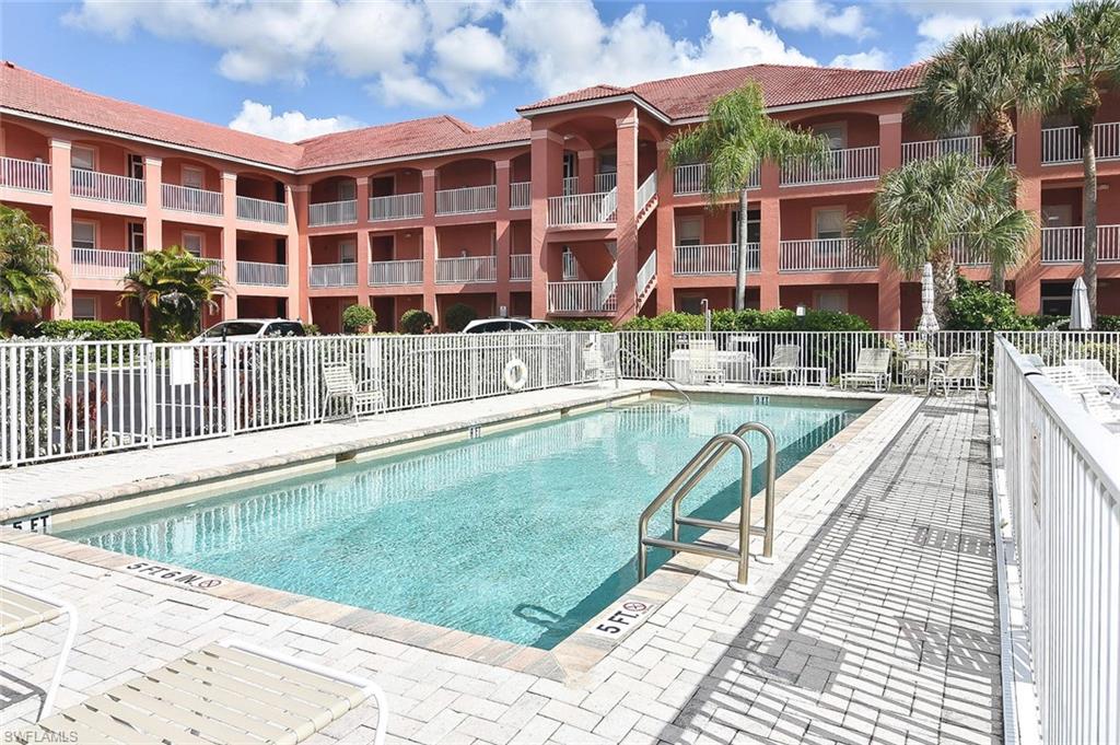 519 Roma Court, Unit 3208 Naples, FL 34110 - Photo 21 of 22 a view of a swimming pool with a lounge chairs