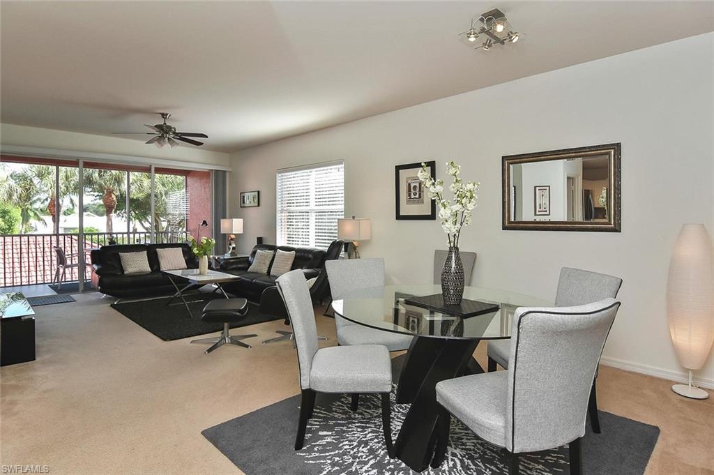 519 Roma Court, Unit 3208 Naples, FL 34110 - Photo 7 of 22 a view of a dining room with furniture a rug and wooden floor
