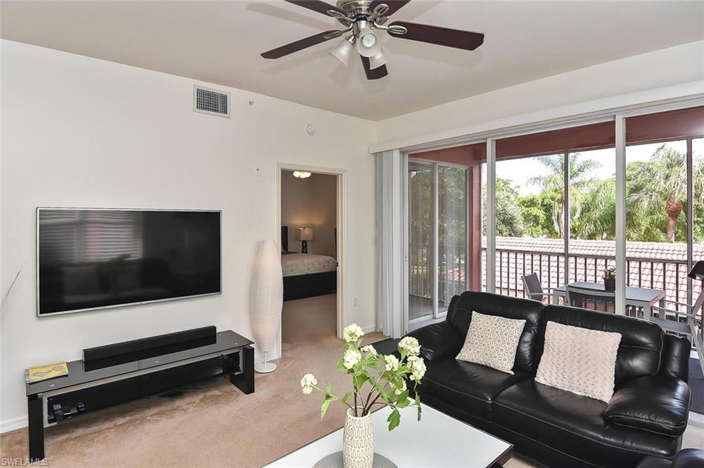 519 Roma Court, Unit 3208 Naples, FL 34110 - Photo 8 of 22 a living room with furniture tv and a window