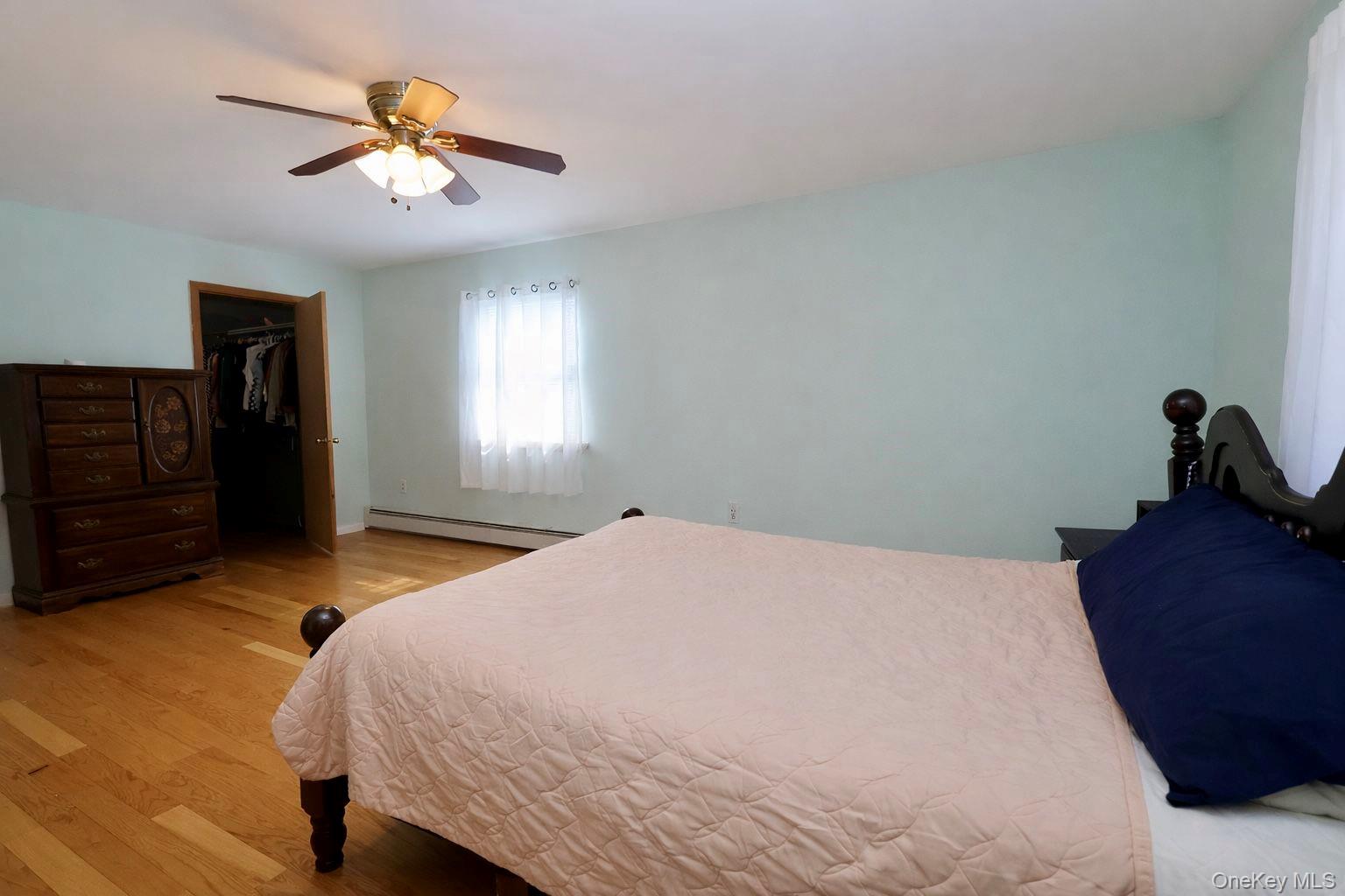 20 Day Road Campbell Hall, NY 10916 - Photo 25 of 41 a bedroom with a bed and a chandelier