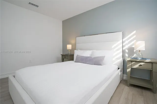 a bedroom with a bed and a large window