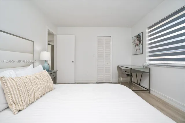 a bedroom with a bed and a table