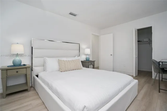 a large white bed in a white room
