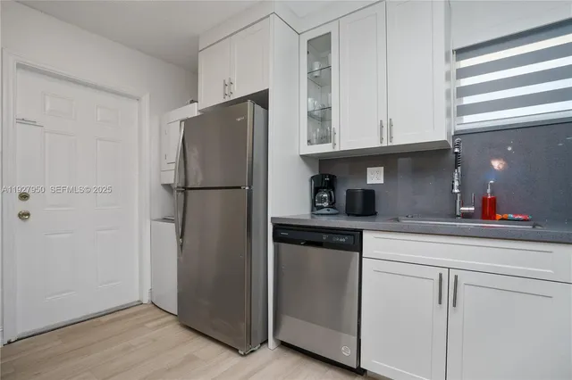 a kitchen with a refrigerator and cabinets