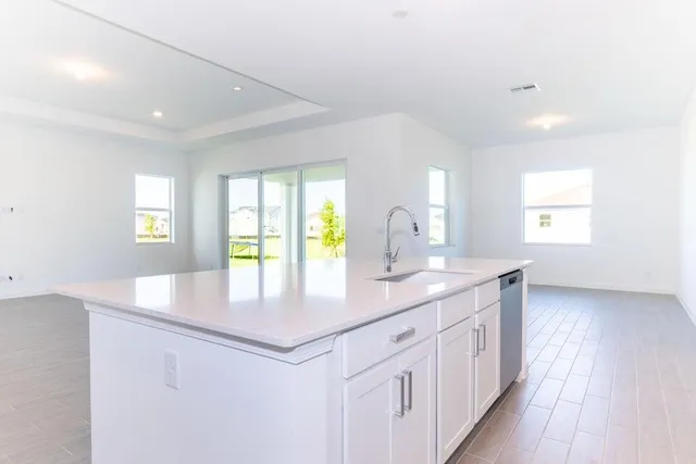 a kitchen with white cabinets and white appliances
