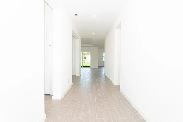 a view of a hallway with wooden floor
