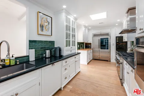a kitchen with a stove top oven and sink