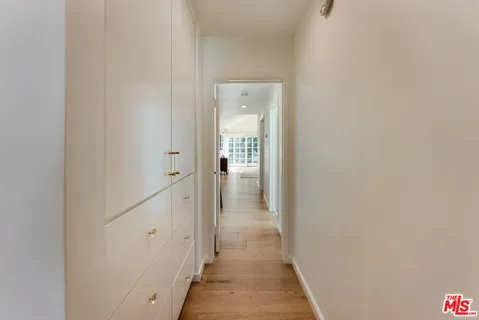 a bedroom with a bed and a flat tv screen on dresser