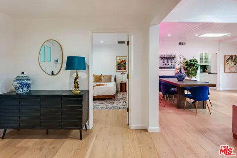 a bedroom with bed and a large window