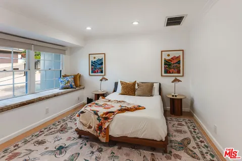 a bed room with a bed and a television