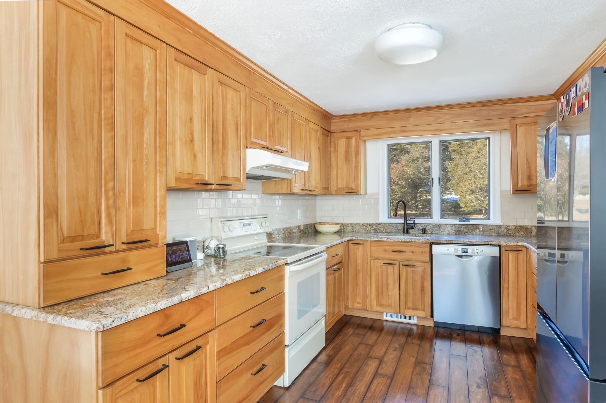 15 Marvin Circle Falmouth, MA 02540 - Photo 19 of 47 a kitchen with stainless steel appliances granite countertop wooden cabinets a sink and dishwasher with wooden floor