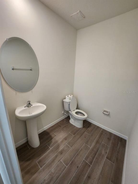 5149 Southwest 48th Lane Gainesville, FL 32608 - Photo 3 of 16 a bathroom with a toilet sink and mirror