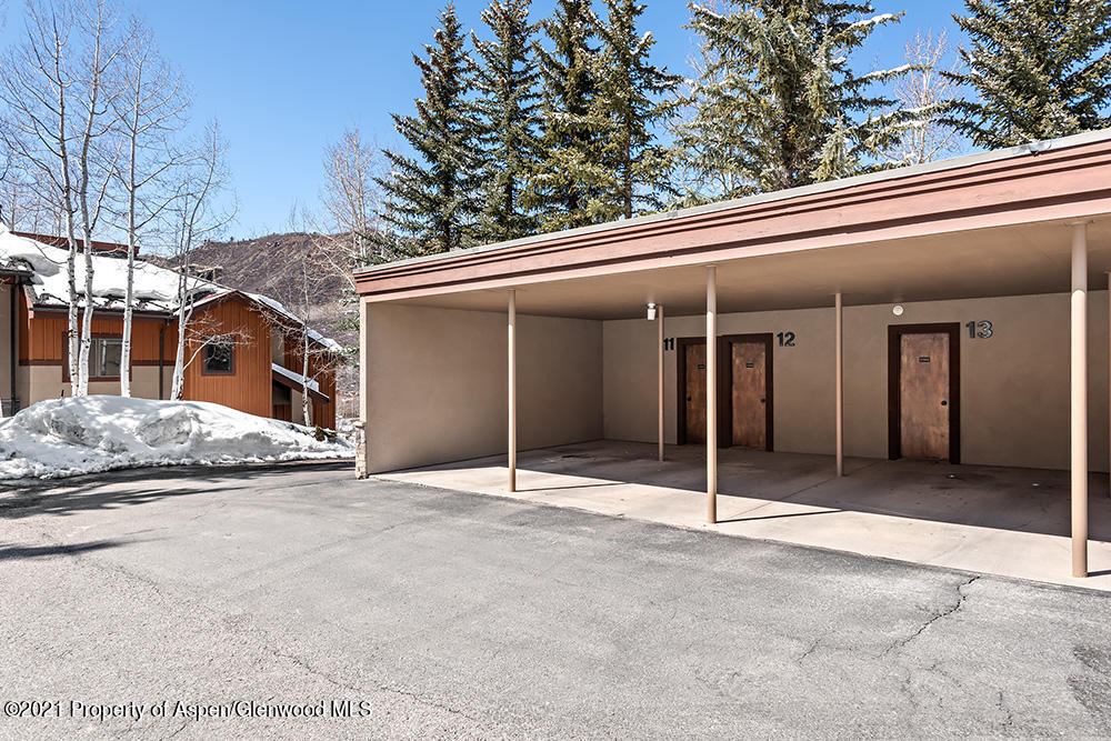 800 Ridge Road, Unit 13 Snowmass Village, CO 81615 - Photo 20 of 23 a house with trees in the background