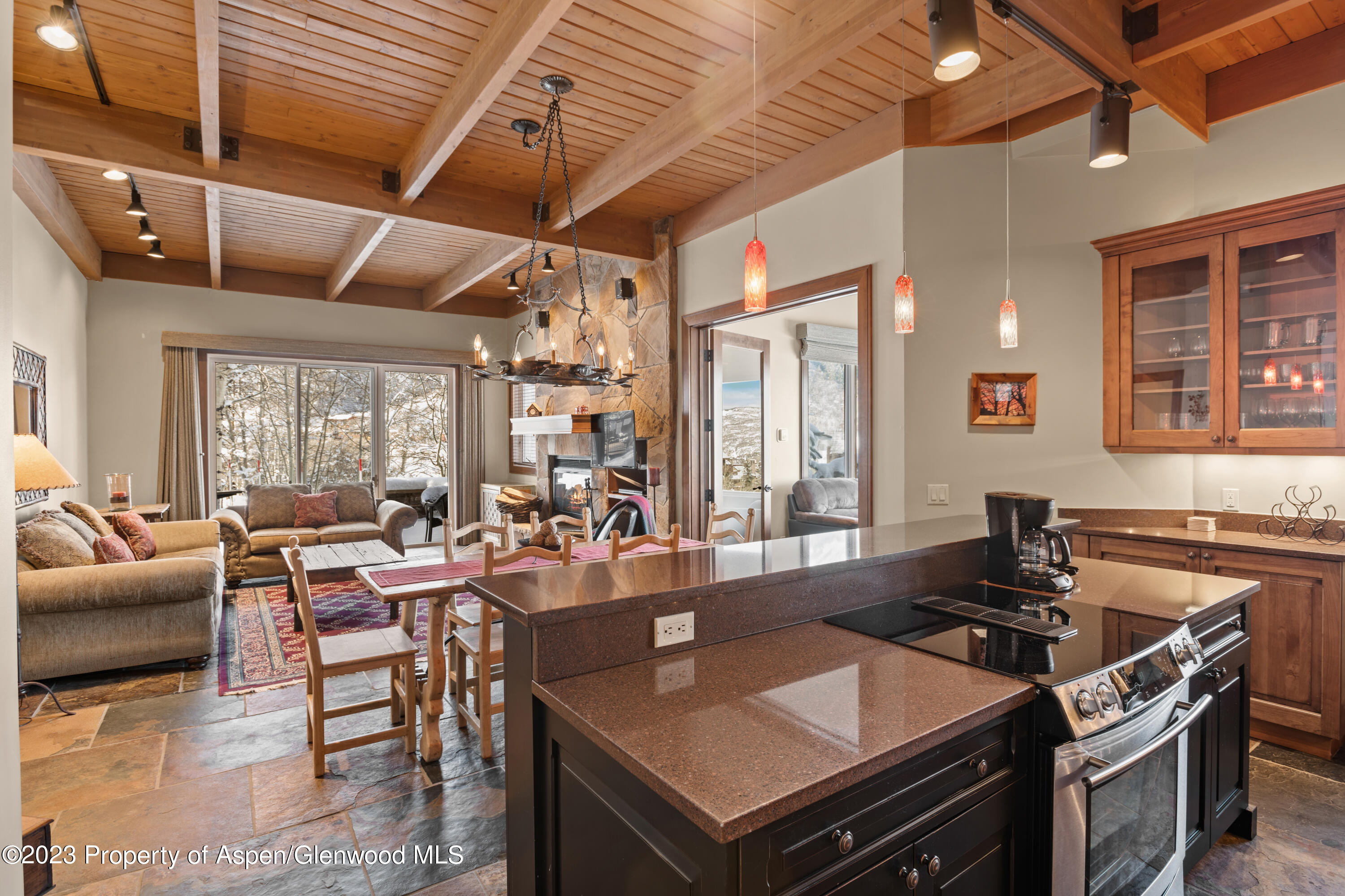 800 Ridge Road, Unit 13 Snowmass Village, CO 81615 - Photo 2 of 23 a large kitchen with a table and chairs