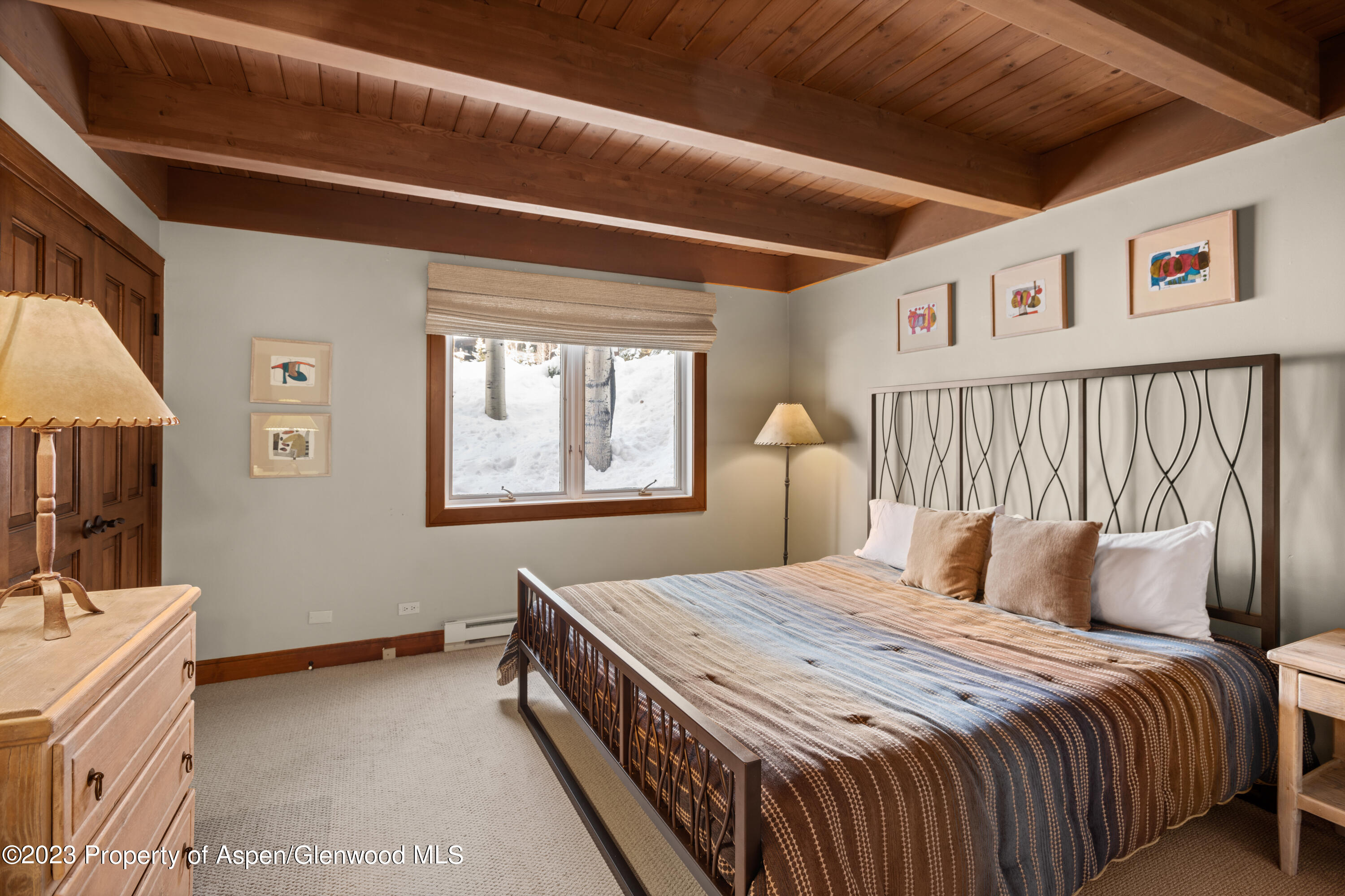 800 Ridge Road, Unit 13 Snowmass Village, CO 81615 - Photo 9 of 23 a bedroom with a large bed and a window
