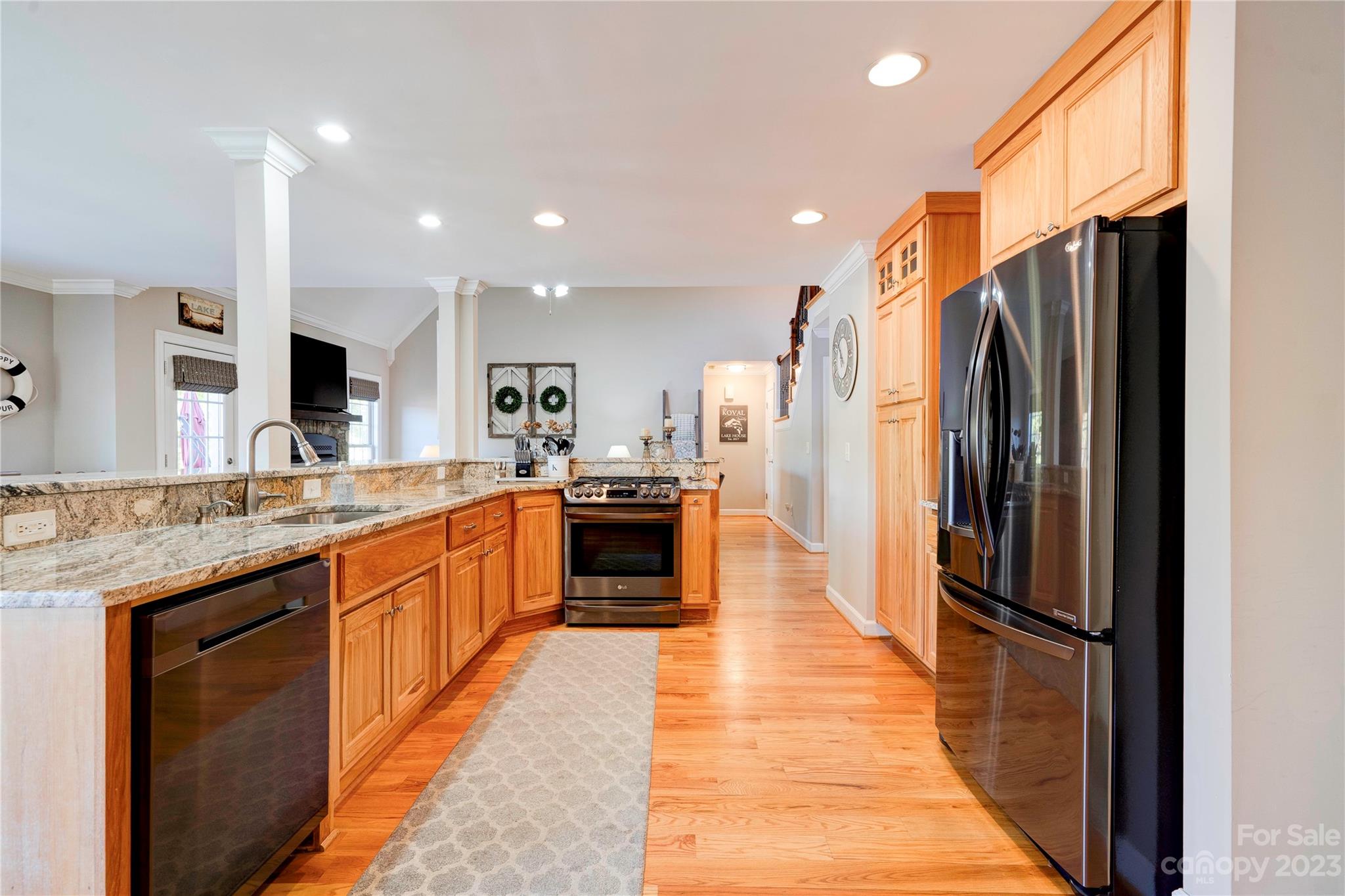 154 Harbor Point Drive Cherryville, NC 28021 - Photo 11 of 40 a large kitchen with stainless steel appliances kitchen island a large counter top a stove a refrigerator and a sink