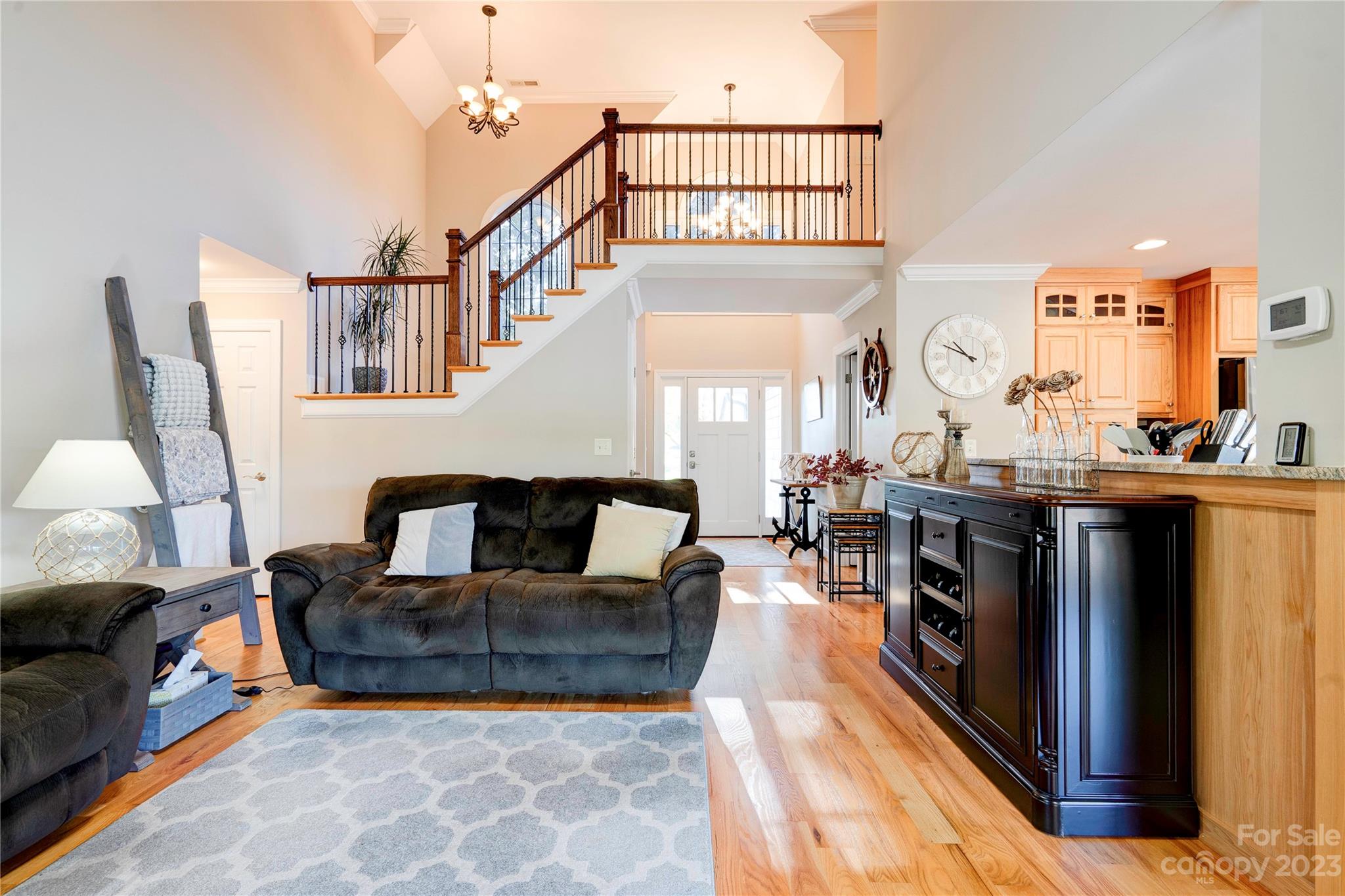 154 Harbor Point Drive Cherryville, NC 28021 - Photo 14 of 40 a living room with furniture a rug and a chandelier