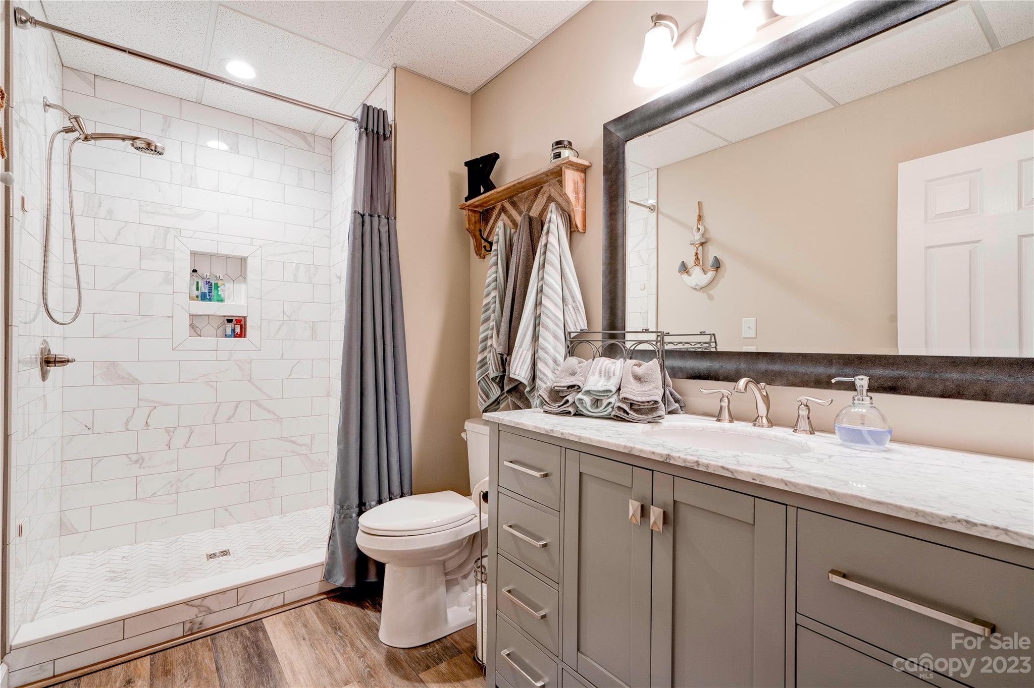 154 Harbor Point Drive Cherryville, NC 28021 - Photo 29 of 40 a bathroom with a granite countertop sink toilet and shower