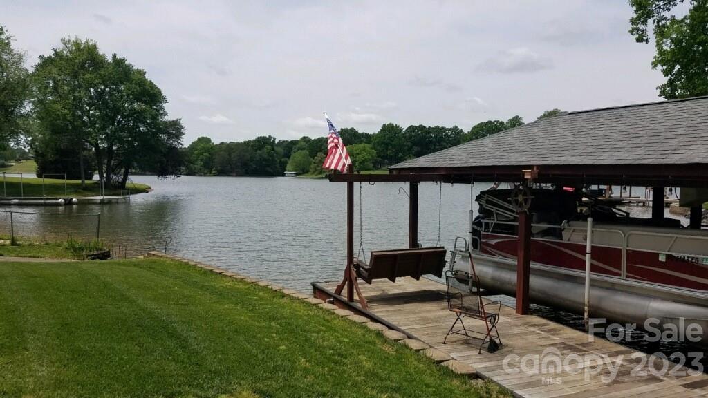154 Harbor Point Drive Cherryville, NC 28021 - Photo 6 of 40 a view of a ocean with a floor to ceiling window and wooden fence