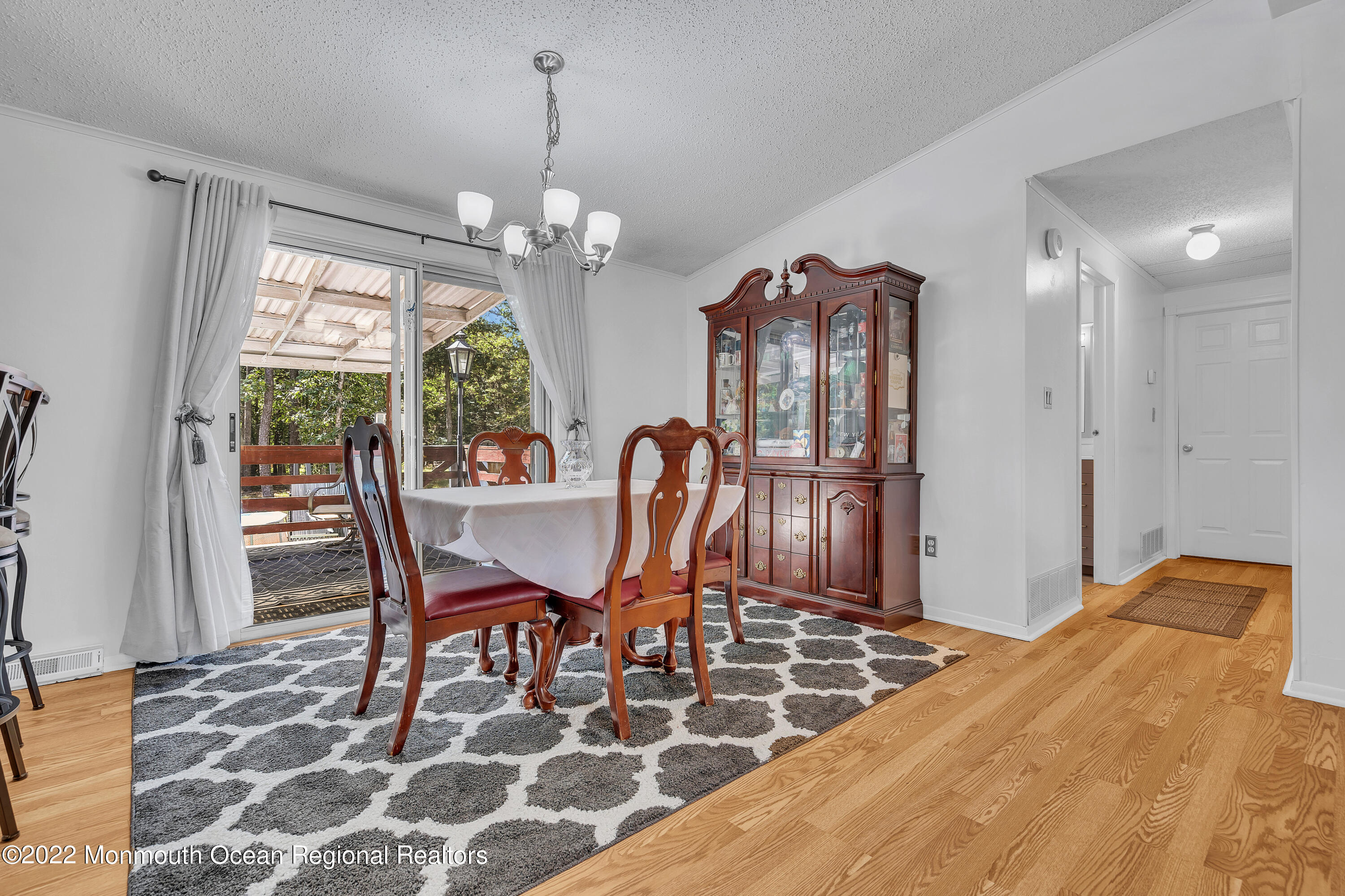 356 Cedar Swamp Road Jackson, NJ 08527 - Photo 12 of 56 a view of a dining room with furniture a chandelier and wooden floor