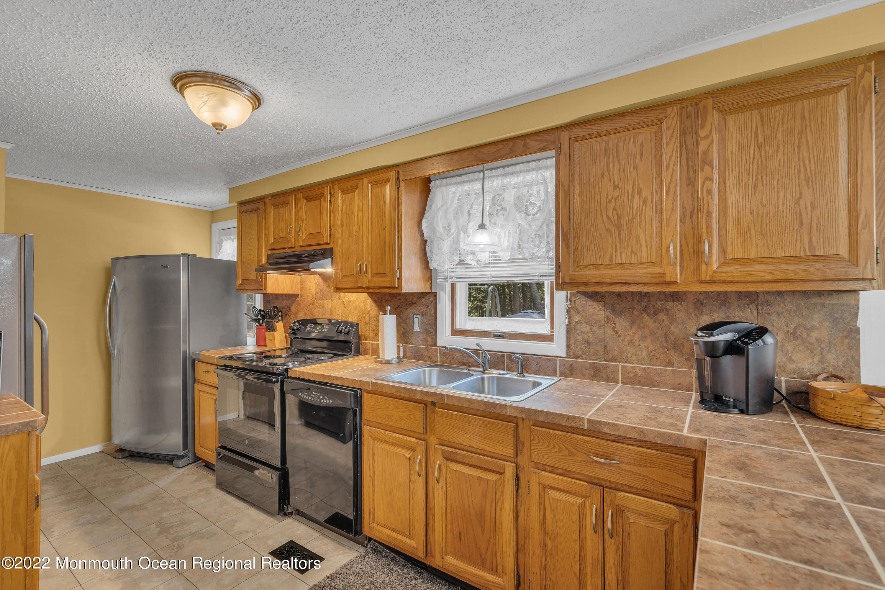 356 Cedar Swamp Road Jackson, NJ 08527 - Photo 16 of 56 a kitchen with stainless steel appliances granite countertop a stove a sink a refrigerator and cabinets