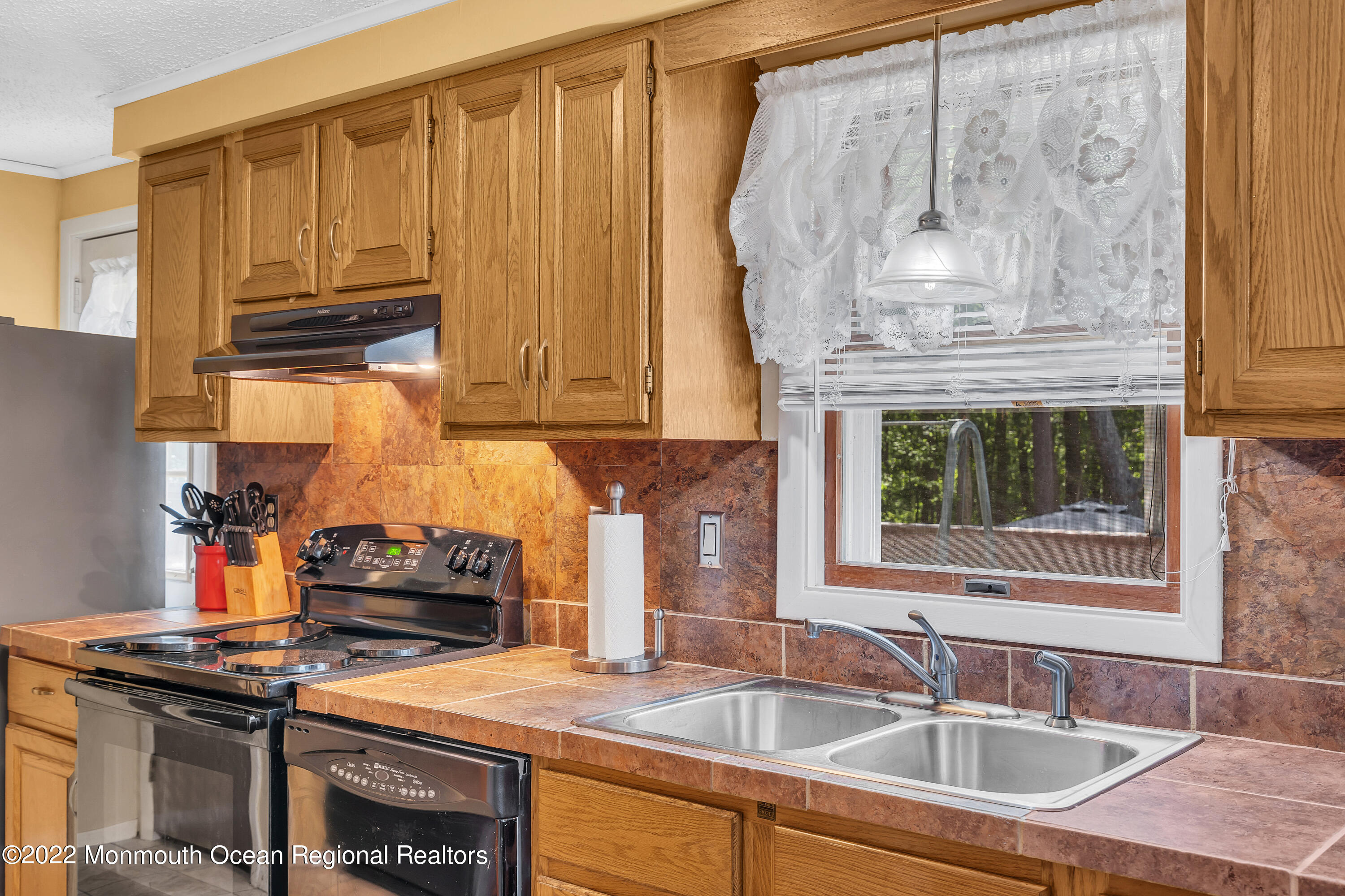 356 Cedar Swamp Road Jackson, NJ 08527 - Photo 17 of 56 a kitchen with stainless steel appliances granite countertop a sink a stove and a wooden cabinets