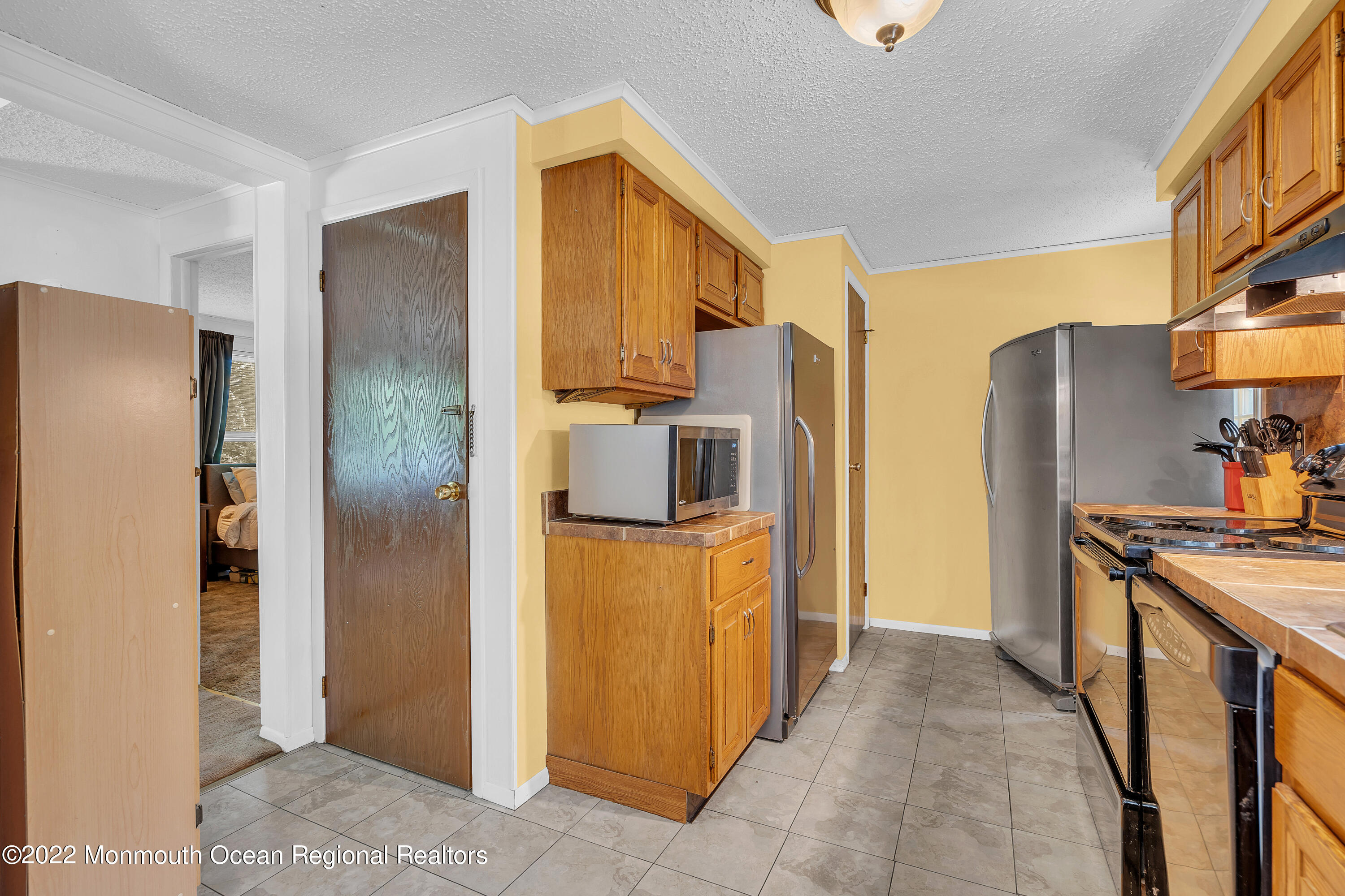 356 Cedar Swamp Road Jackson, NJ 08527 - Photo 18 of 56 a kitchen with stainless steel appliances granite countertop a refrigerator and a stove