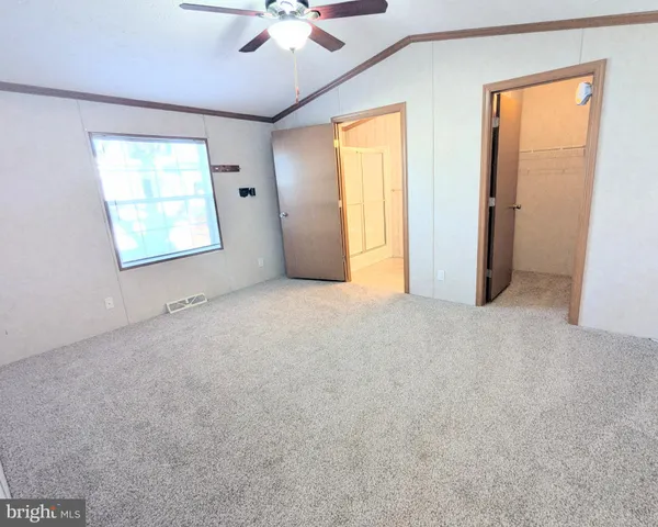 an empty room with windows and closet