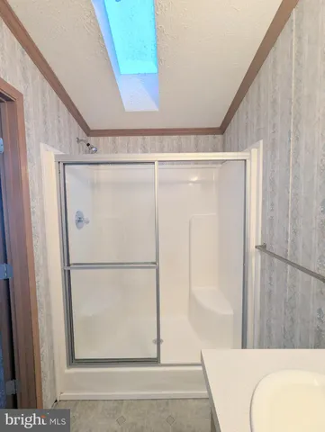 a bathroom with a shower and a sink