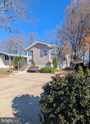 a front view of a house with a yard and a garage