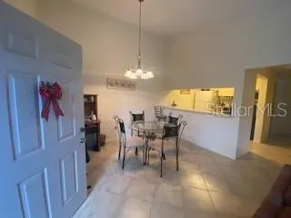 a view of a dining room with furniture and chandelier