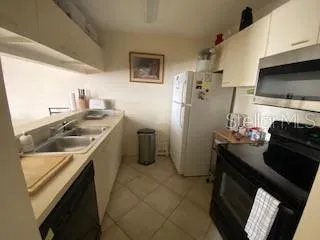 a kitchen with a sink appliances and cabinets