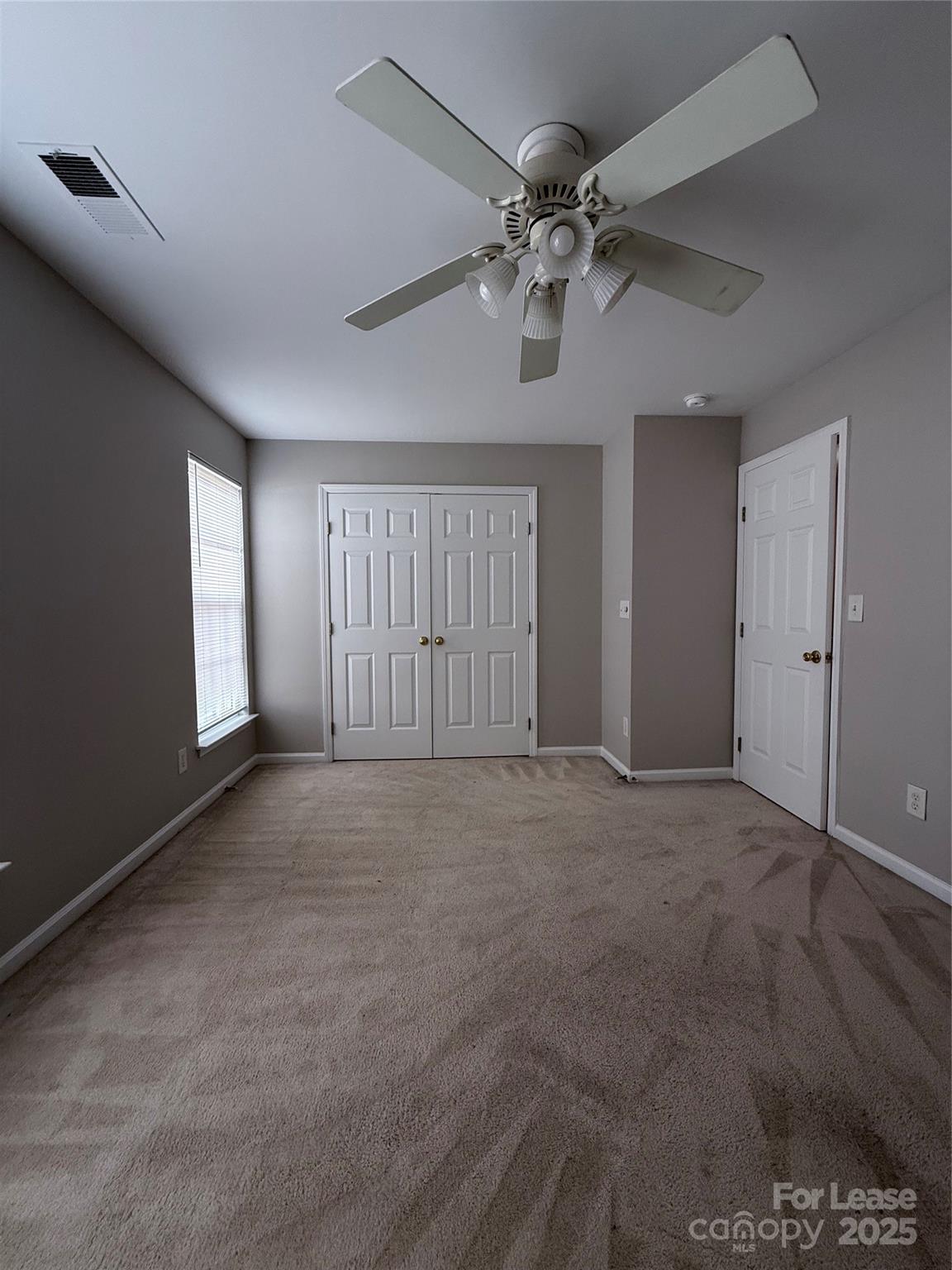 4968 Prosperity Ridge Road Charlotte, NC 28269 - Photo 12 of 19 a view of an empty room with a chandelier fan