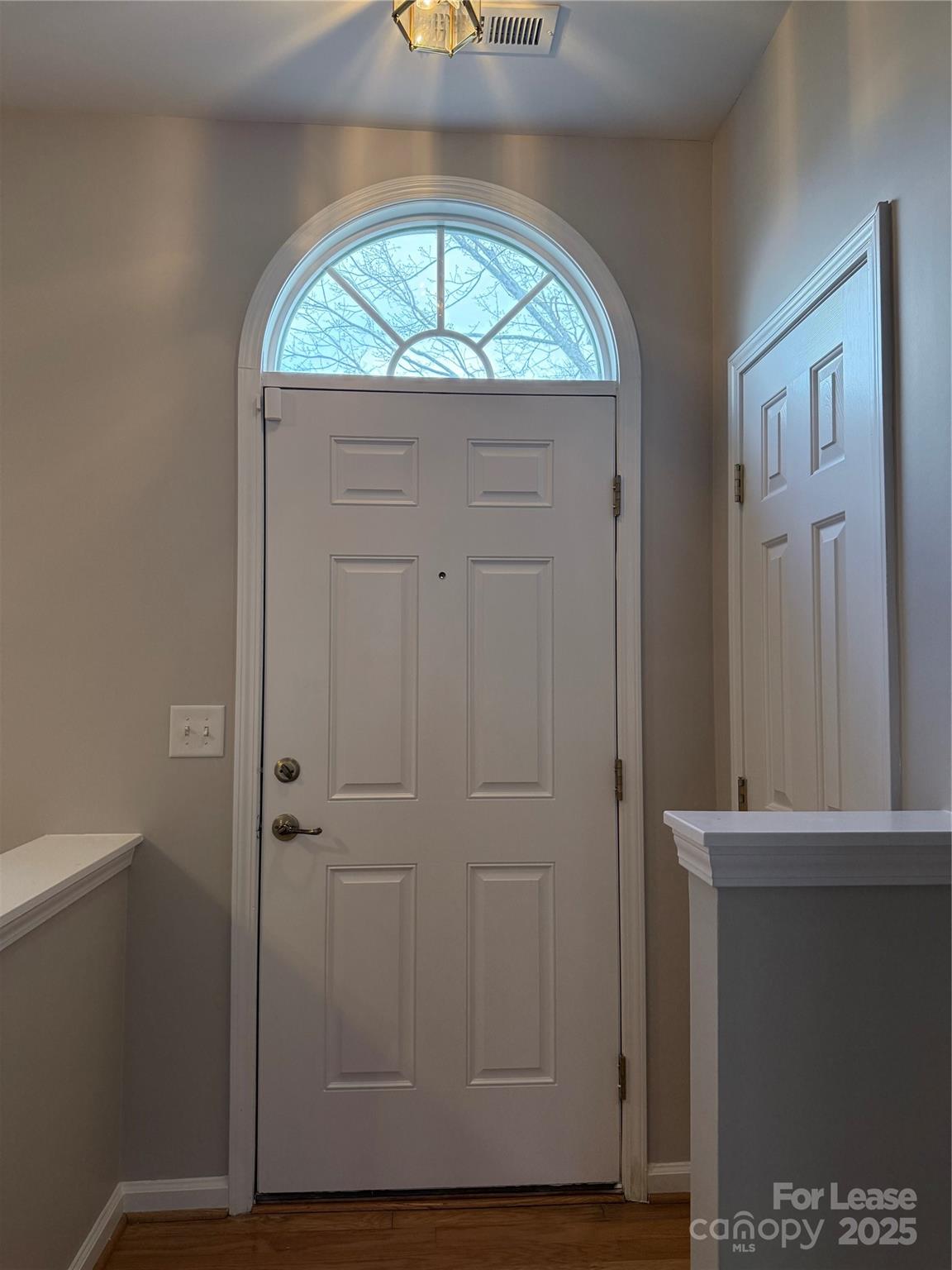 4968 Prosperity Ridge Road Charlotte, NC 28269 - Photo 2 of 19 an empty room with wooden floor closet and windows