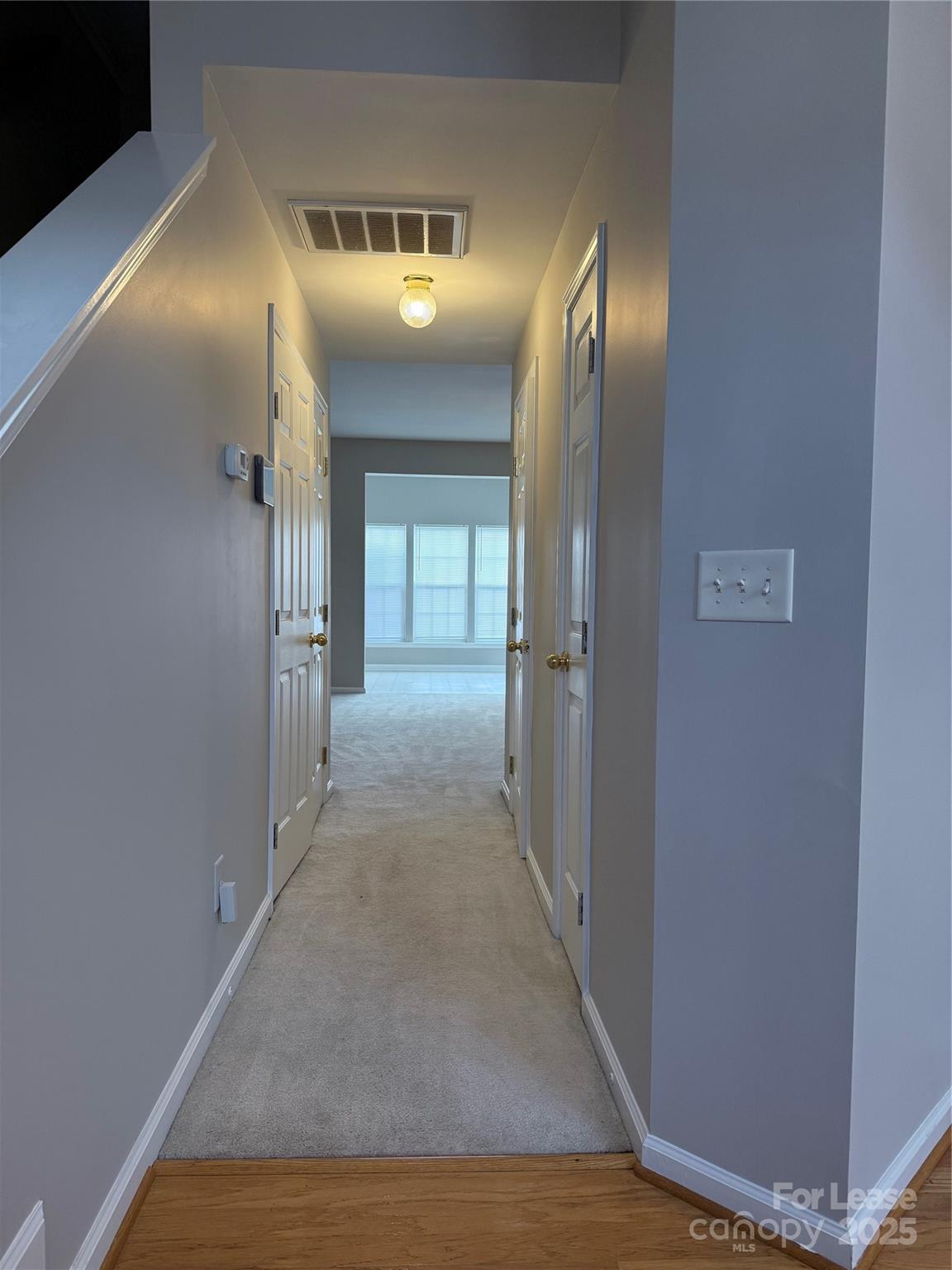 4968 Prosperity Ridge Road Charlotte, NC 28269 - Photo 6 of 19 a view of a hallway with wooden floor