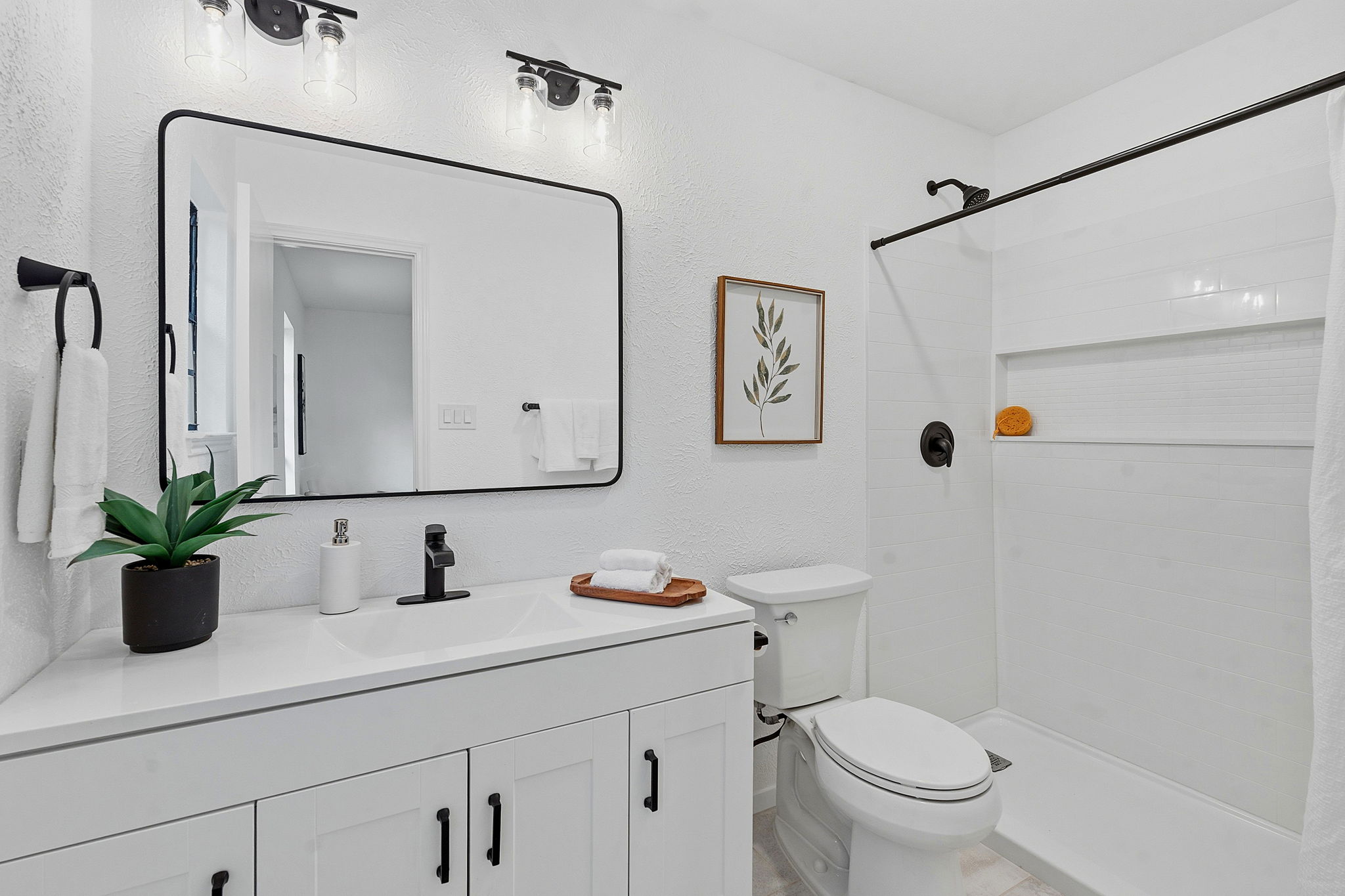 2702 Calabash Cove Austin, TX 78745 - Photo 30 of 40 a bathroom with a sink mirror toilet and shower