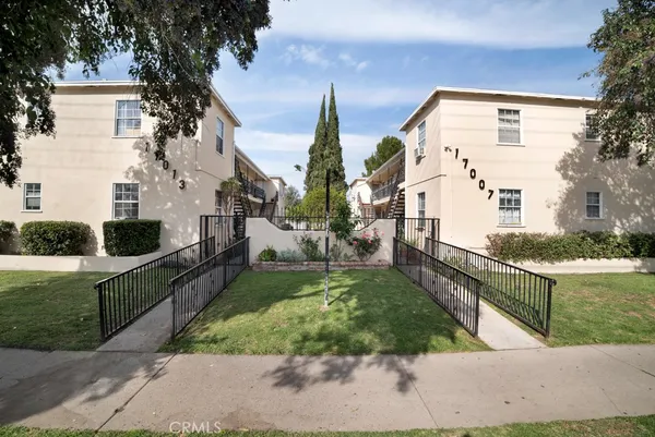 a view of a house with a yard and plants