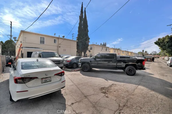 a view of a car in the back yard of the house