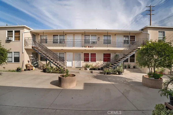 a view of a house with sitting area and potted plants