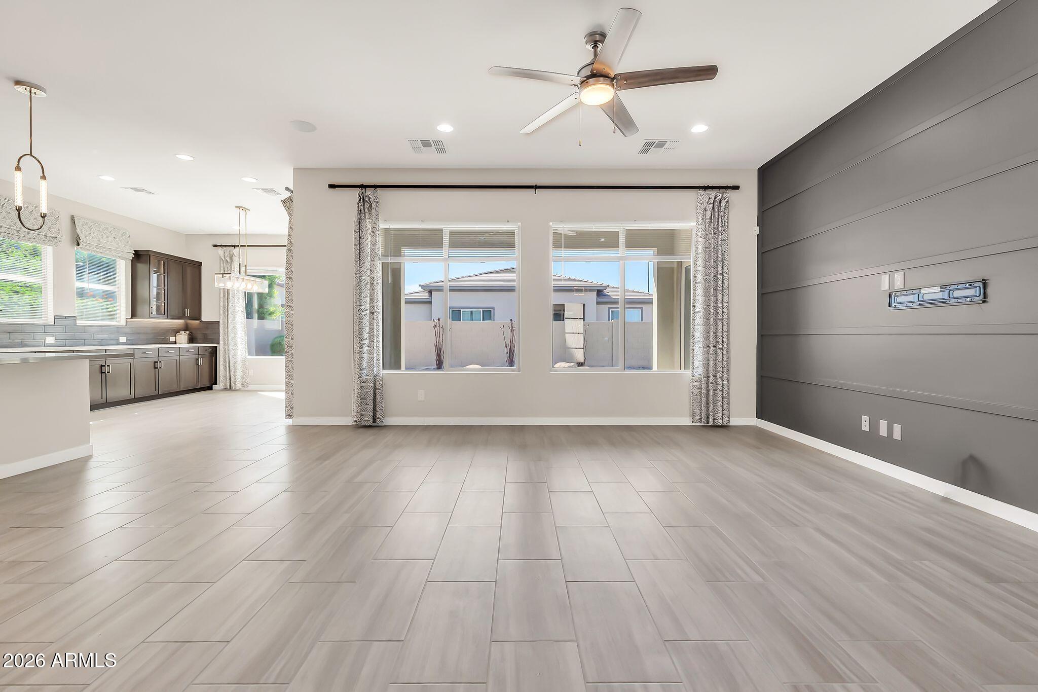 1441 East Powell Way Gilbert, AZ 85298 - Photo 11 of 63 a view of an empty room with a window and wooden floor