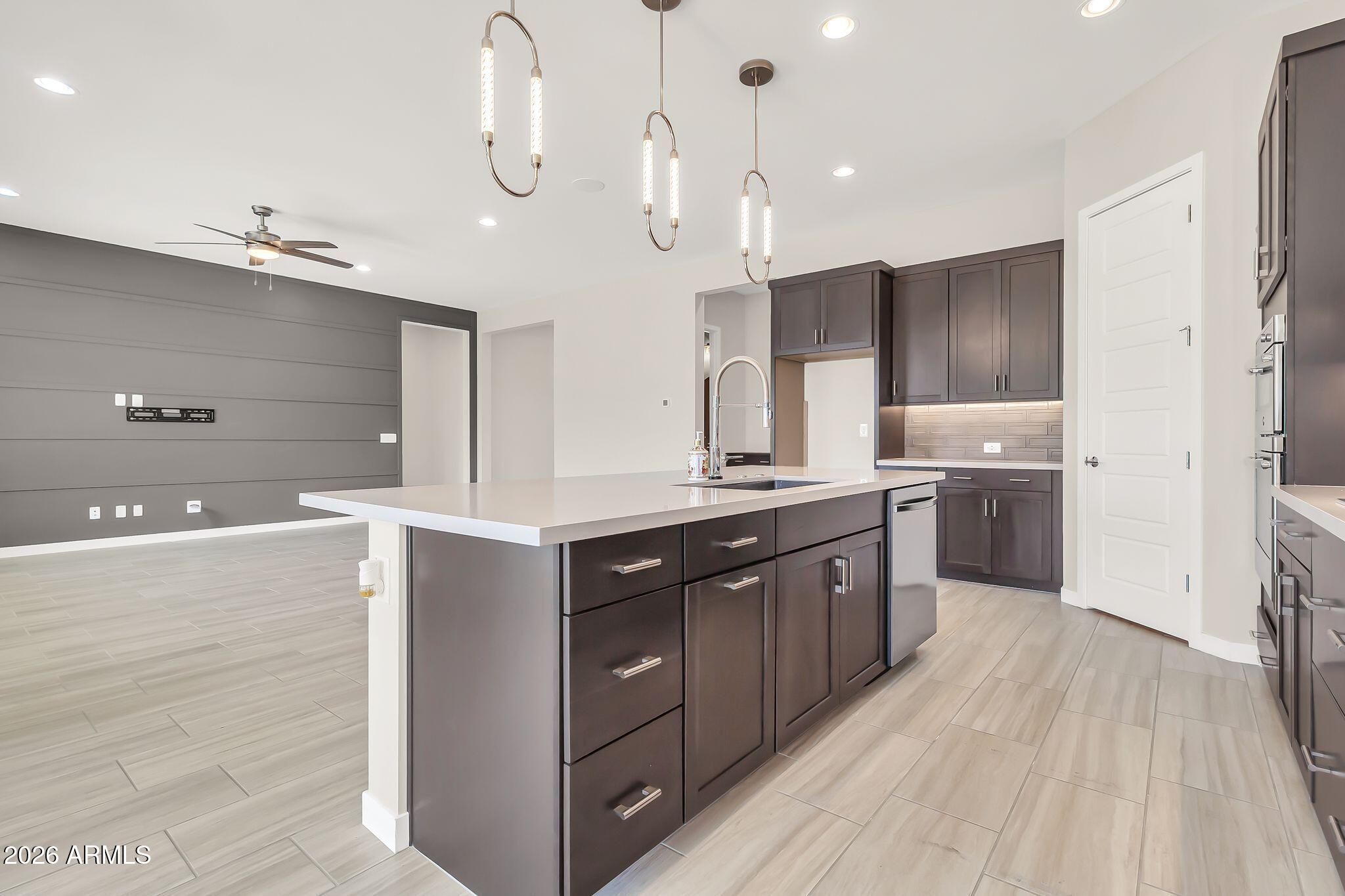 1441 East Powell Way Gilbert, AZ 85298 - Photo 18 of 63 a large kitchen with kitchen island a sink stainless steel appliances and cabinets