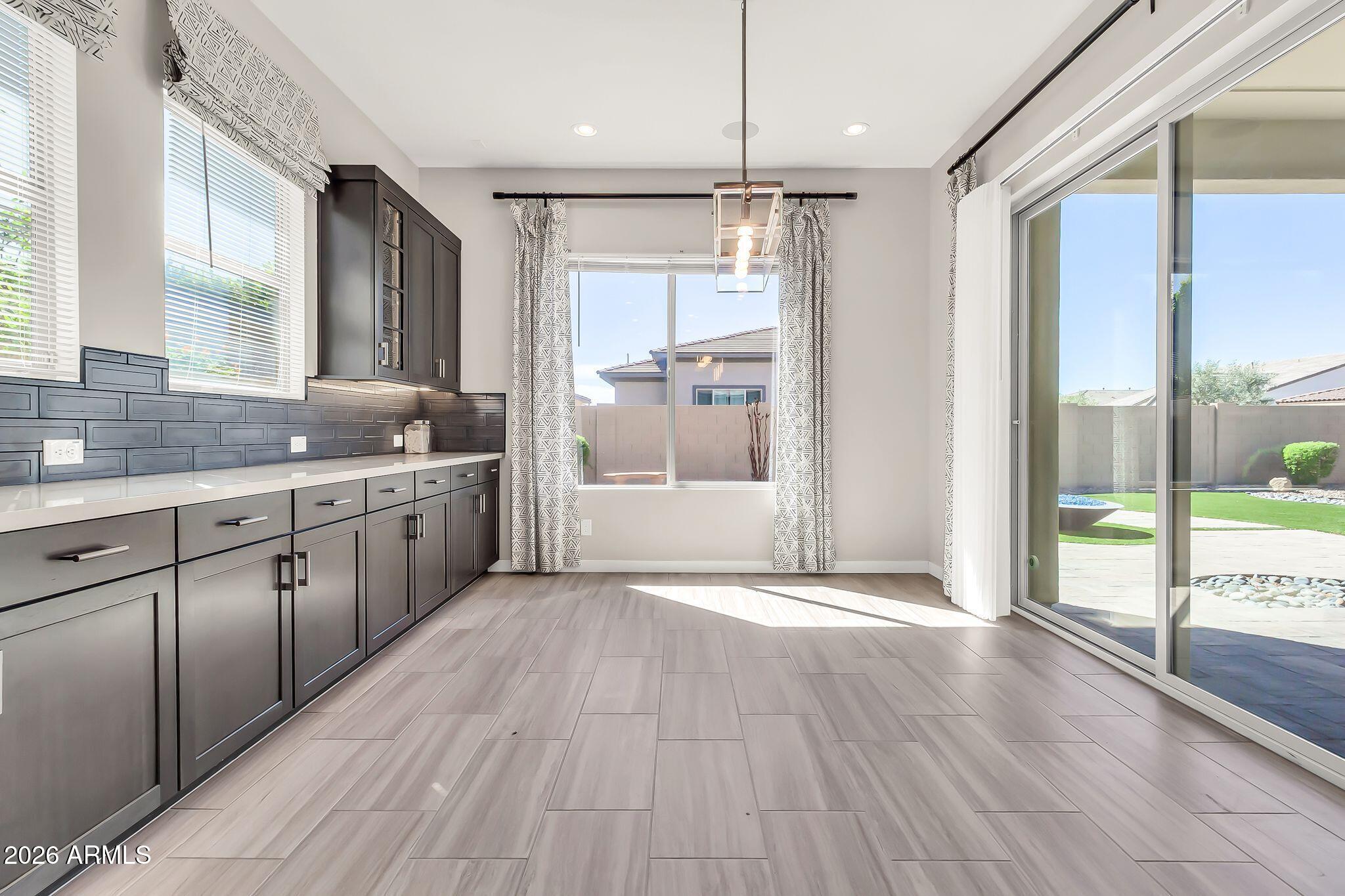1441 East Powell Way Gilbert, AZ 85298 - Photo 20 of 63 a view of a large kitchen with a sink and wooden floor