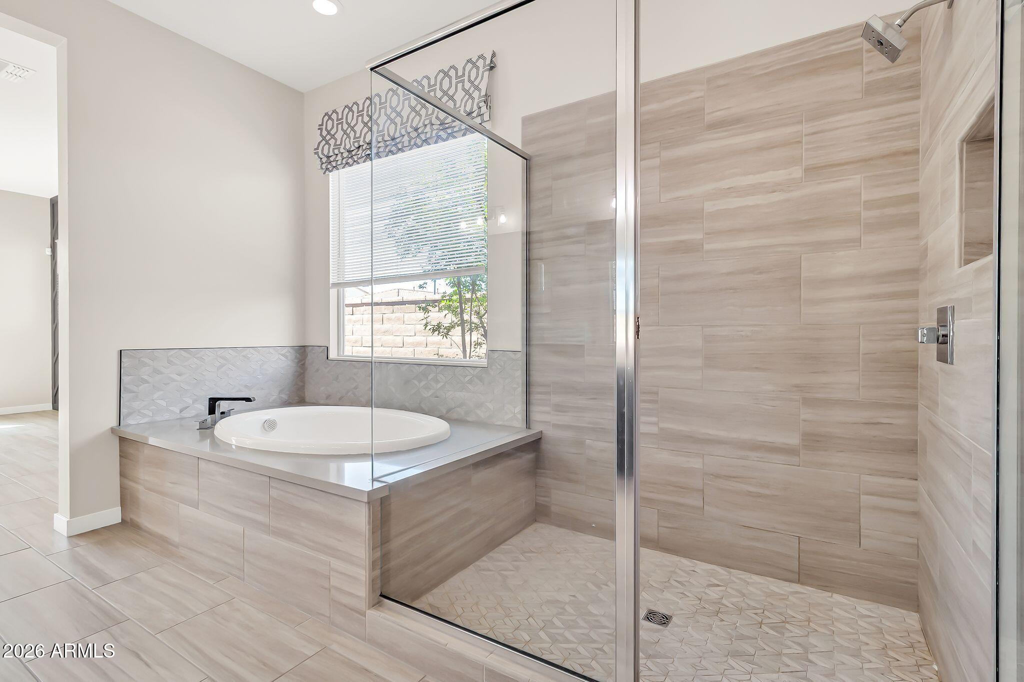 1441 East Powell Way Gilbert, AZ 85298 - Photo 28 of 63 a bathroom with a tub sink and mirror