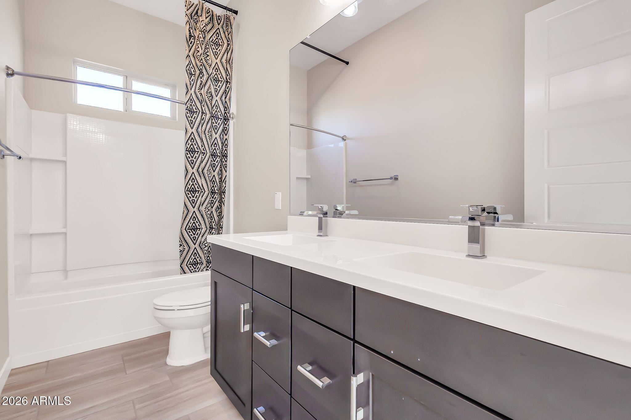 1441 East Powell Way Gilbert, AZ 85298 - Photo 36 of 63 a bathroom with a double vanity sink toilet mirror and shower