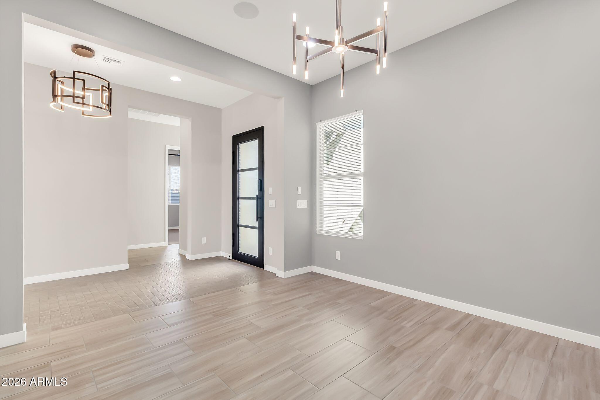 1441 East Powell Way Gilbert, AZ 85298 - Photo 41 of 63 an empty room with wooden floor ceiling fan and windows