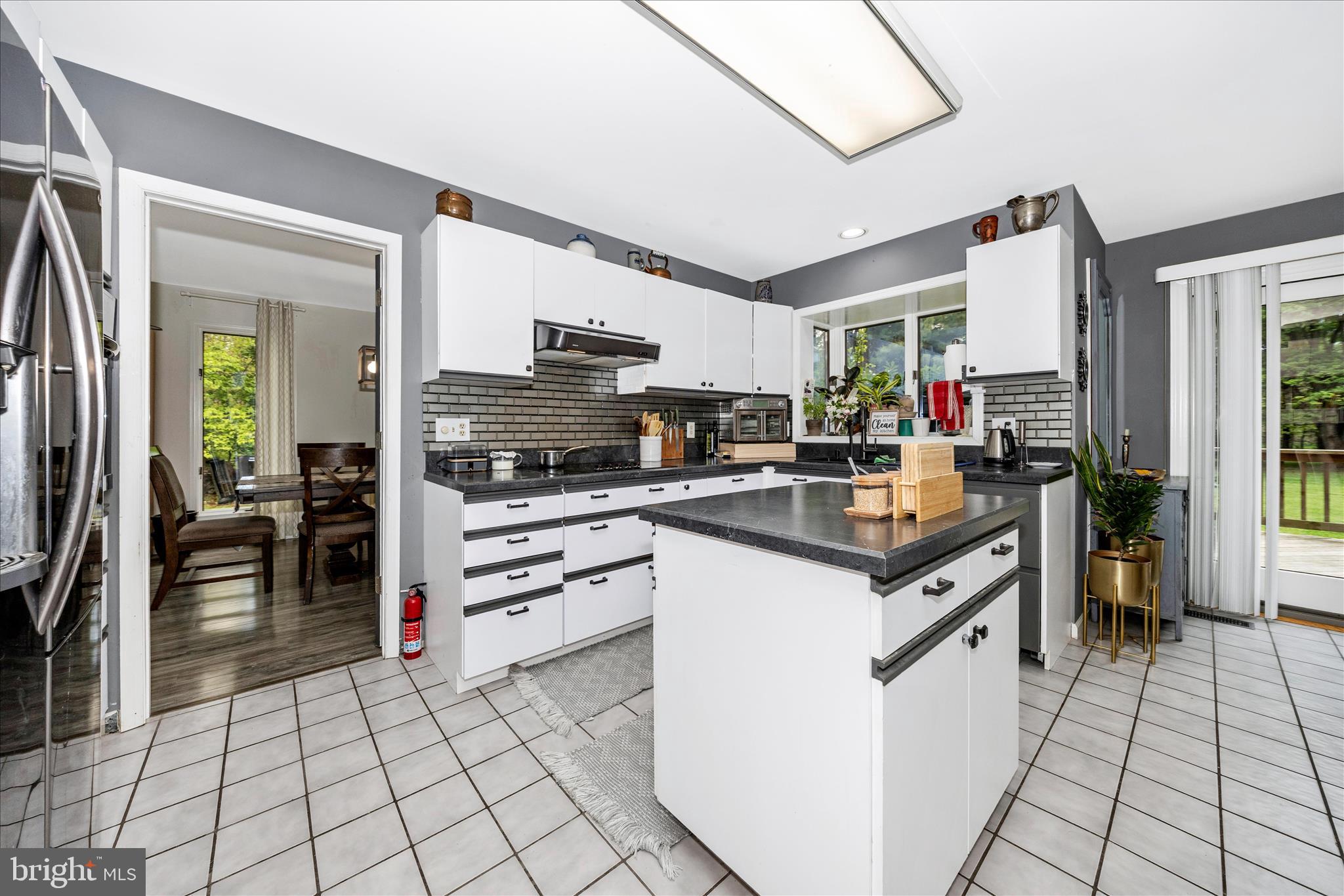 15749 Spade Road Hagerstown, MD 21740 - Photo 5 of 23 a kitchen with kitchen island granite countertop a stove top oven a sink a counter top space and cabinets