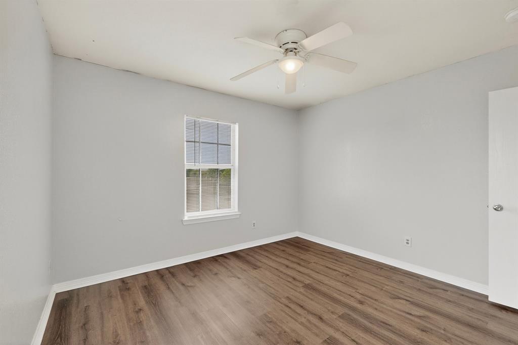 3401 Newgate Street Midlothian, TX 76065 - Photo 30 of 34 Spacious room featuring wood-finish flooring, light grey walls, and a white ceiling fan with integrated lighting