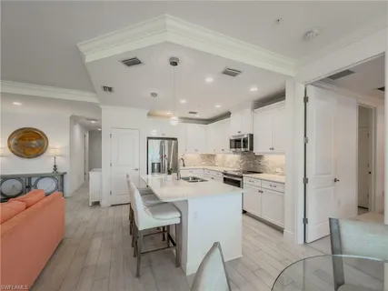 a kitchen with stainless steel appliances kitchen island granite countertop a sink and cabinets