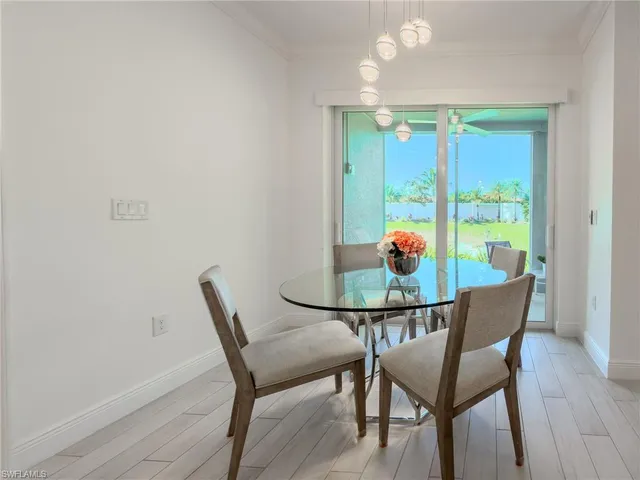 a dining room with furniture and wooden floor