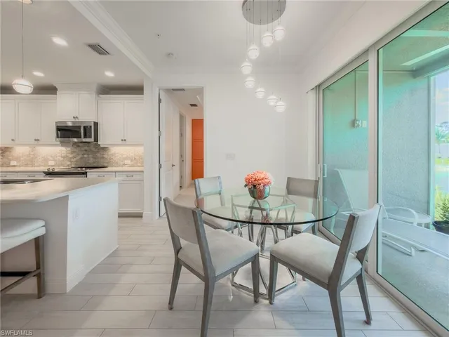 a kitchen that has a table and chairs in it